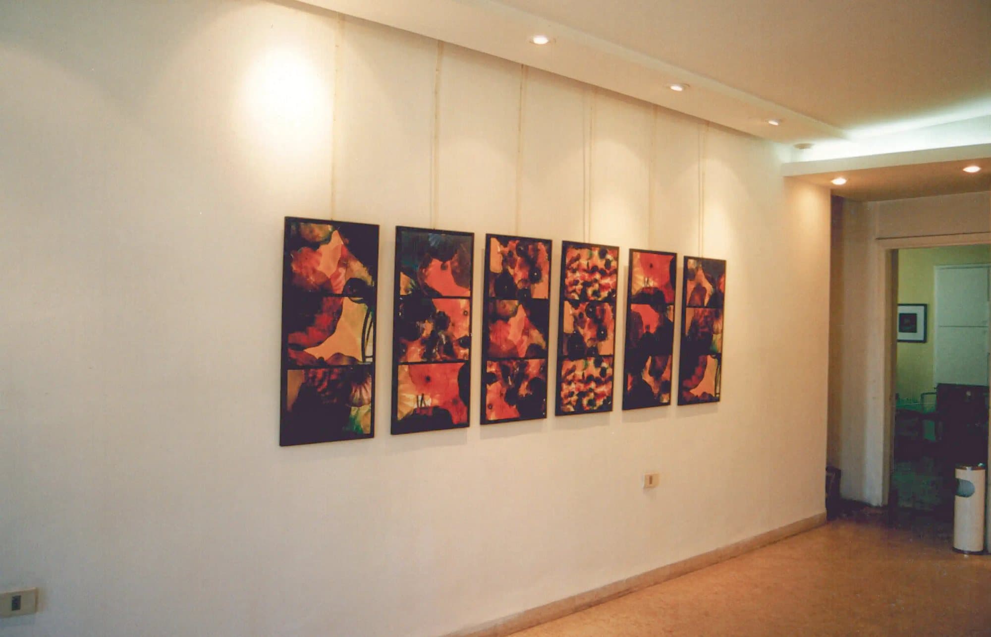 A wall of paintings hung in the gallery